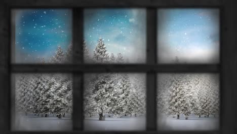 Wooden-window-frame-against-snow-falling-over-multiple-trees-on-winter-landscape