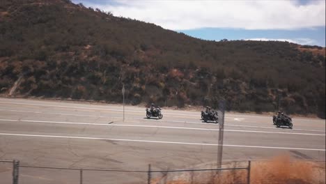 Aerial-drone-footage,-this-team-of-Deputy-Sheriffs-ride-down-the-street-in-formation