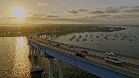 San-Diego-California-Aerial-v99-cinematic-fly-along-side-the-curve-of-coronado-bridge-towards-tidelands-park-capturing-picturesque-golden-sunset-city-skyline---Shot-with-Mavic-3-Cine---September-2022