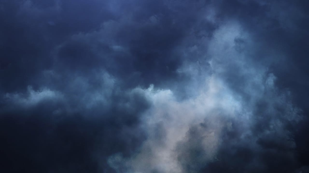 4K thunderstorm accompanied by lightning strike in dark sky