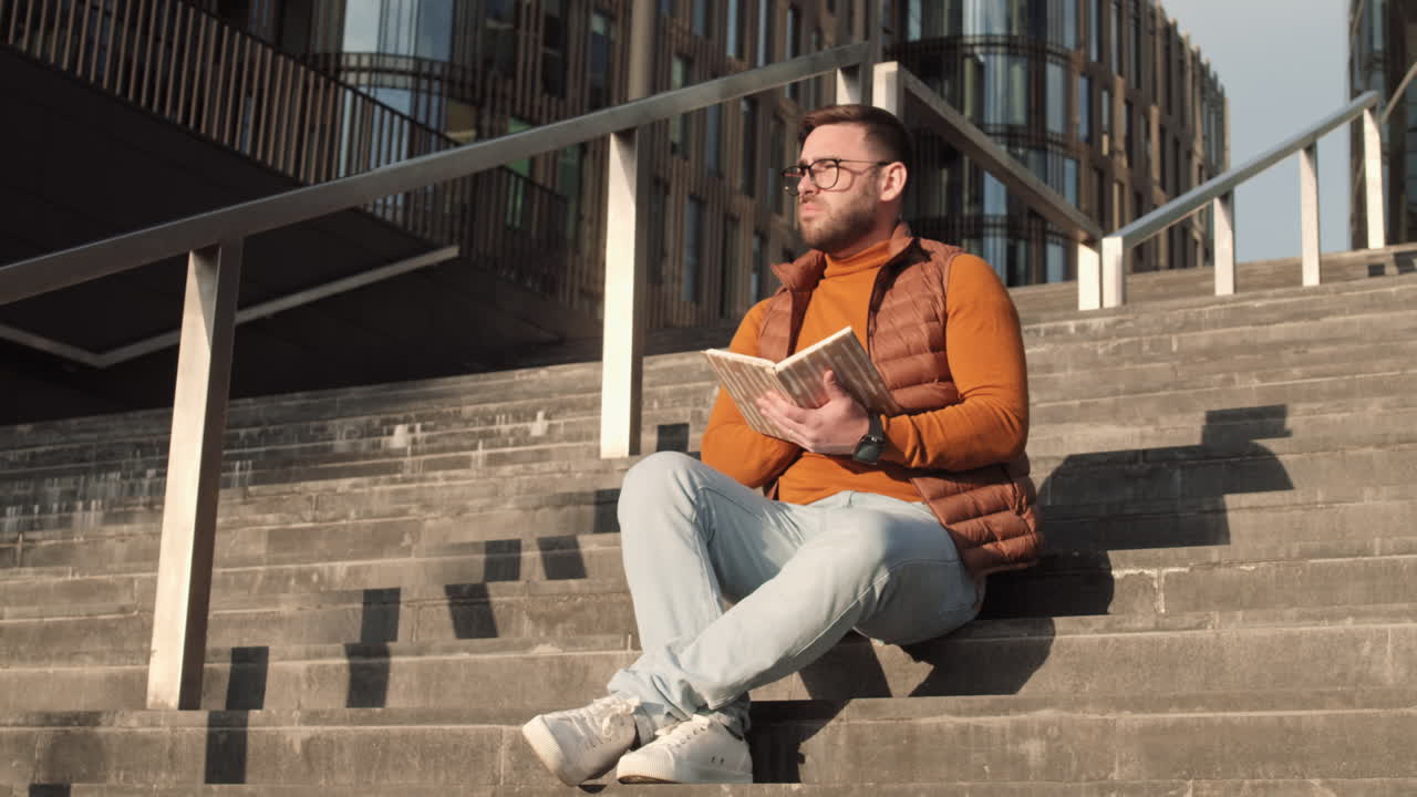 Man Reading on Stairs Outdoors