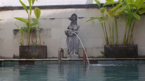 footage of a pool fountain sculpture and an old pool in bali