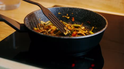 cooking green beans in a pan