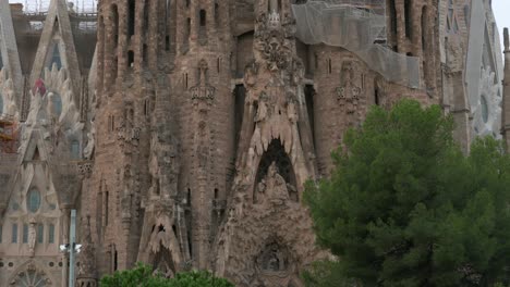 Tilt-up-view-of-showcasing-the-Sagrada-Familia,-the-largest-unfinished-Catholic-church-in-the-world-and-part-of-a-UNESCO-World-Heritage-Site