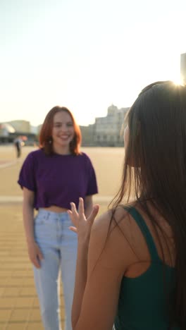 two women enjoying a rooftop conversation