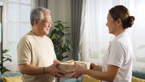 a heartwarming moment of generosity: a smiling senior citizen receives a thoughtfully wrapped package from a cheerful delivery person in bright, sunlit room