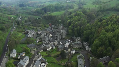 misty green french valley and hamlet with breathtaking views, aerial