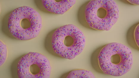 pink glaze donuts on a yellow background
