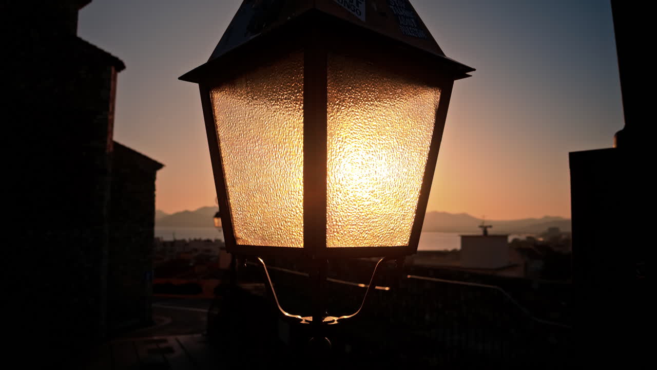 Close up of a street lamp with a blurry city view of Monaco