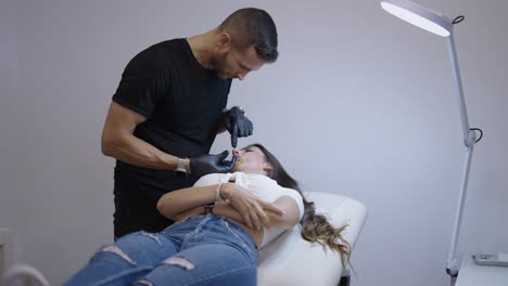 professional performs an oral procedure on a woman in a clinic