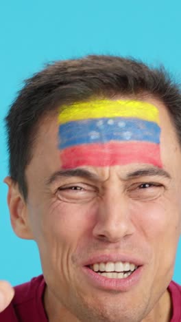 close up of a man supporting venezuelan team
