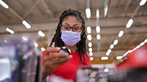 latin young woman wearing a face mask shopping make up