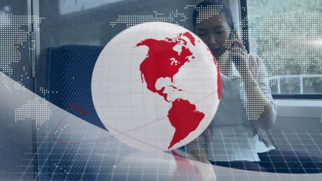animation of red and white globe and map, over businesswoman on train talking on smartphone