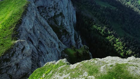 eroded white cliffs with grass on top, shadowed valley below, vietnam