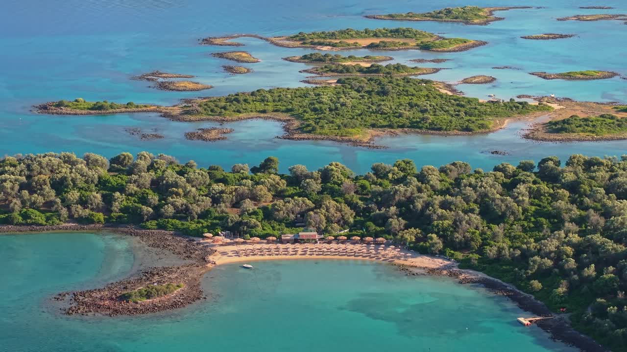 Drone footage over a beach at Lichadonisia in Evoikos Gulf reveals the full island complex surrounded by turquoise waters and natural beauty