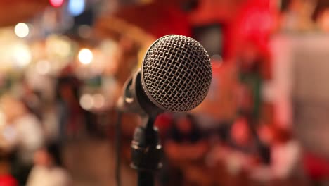 Microphone-on-stage-against-a-background-of-auditorium.