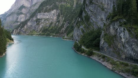 the most vivid blue lake river gateway between great gigantic mountains mainly made of stone small road path for travellers hikers people who like to explore nature perfect destination for adventure