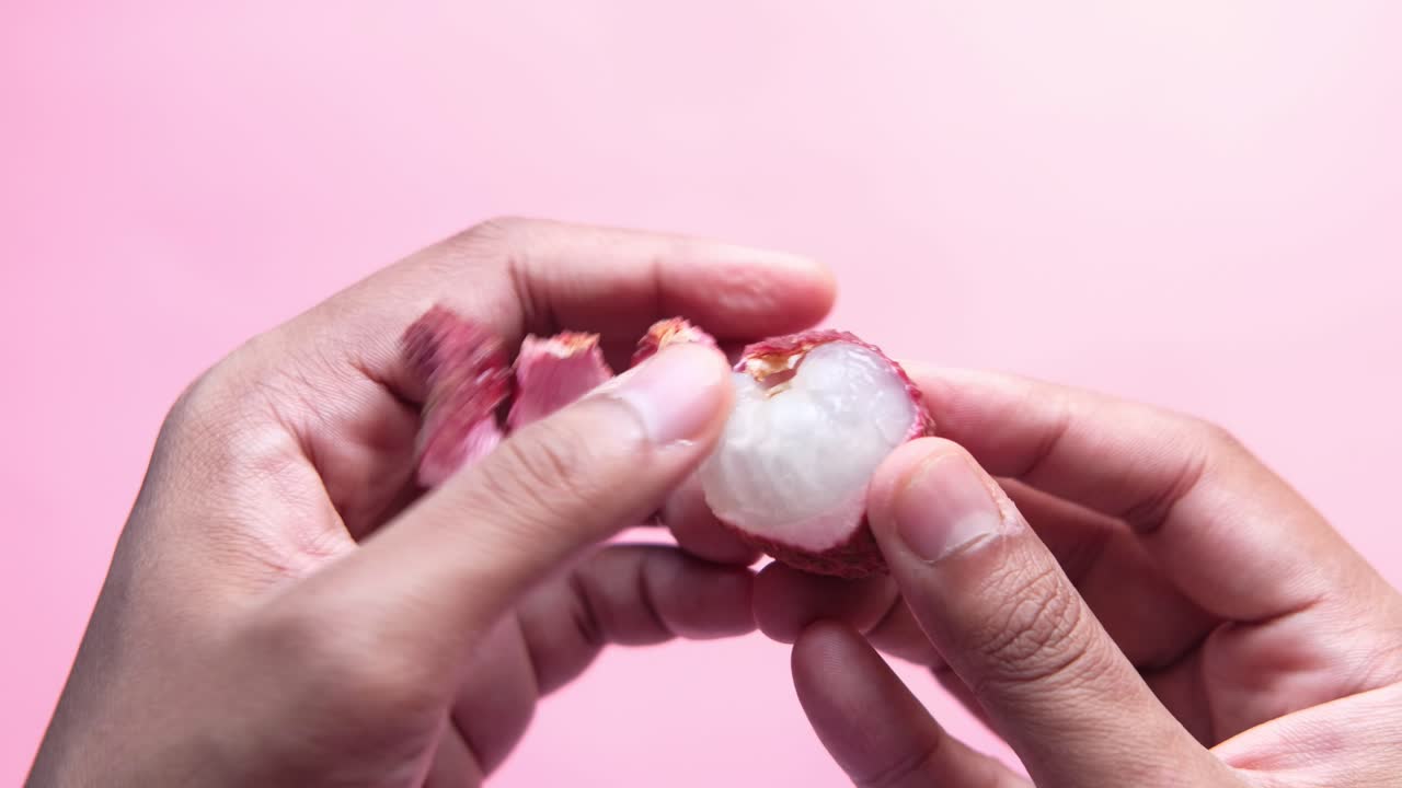 manos sosteniendo un lychee cortado