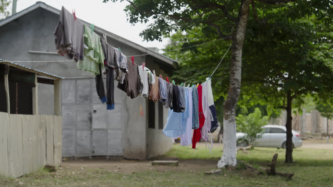 Rural backyard with hanging laundry drying on clothesline as daily cultural habit of Kenya, Africa