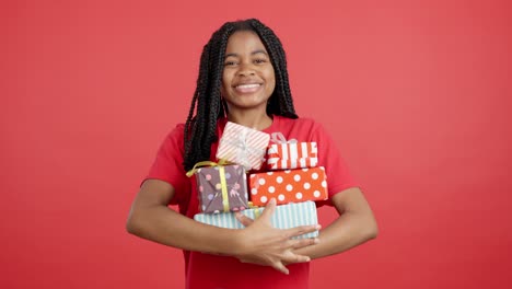 happy woman holding a stack of wrapped gifts