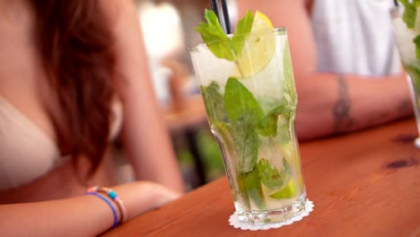 close-up of mojito cocktails served on summer bar counter