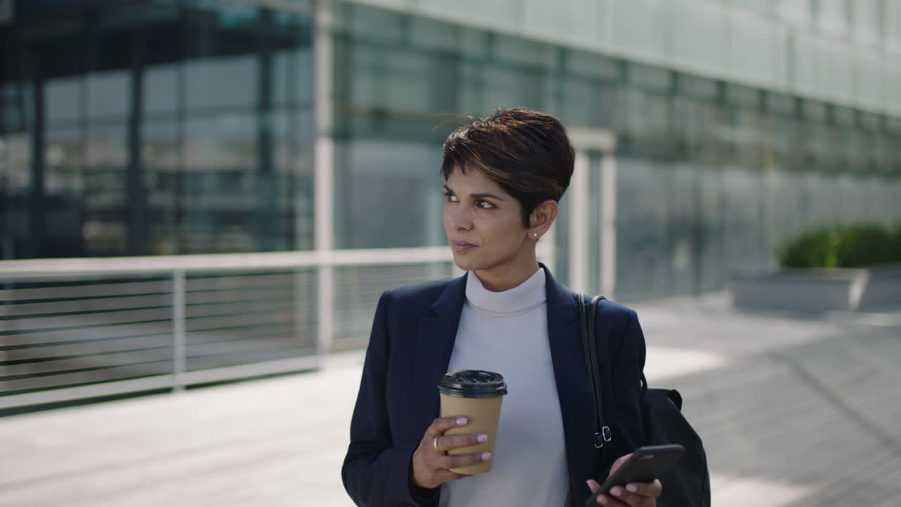 portrait of attractive professional business woman leader using smartphone mobile technology checking messages browsing networking