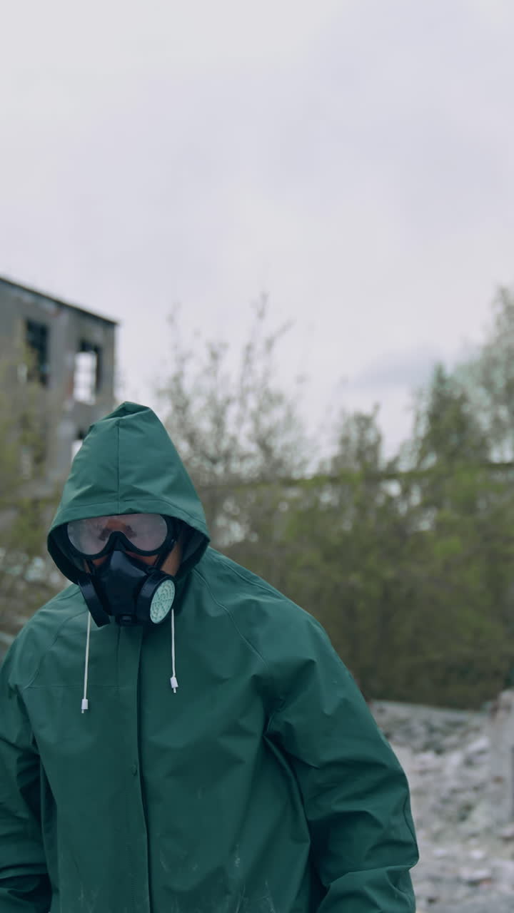 Man in protective suit and antigas mask with glasses. Safety virus infection concept. Vertical video