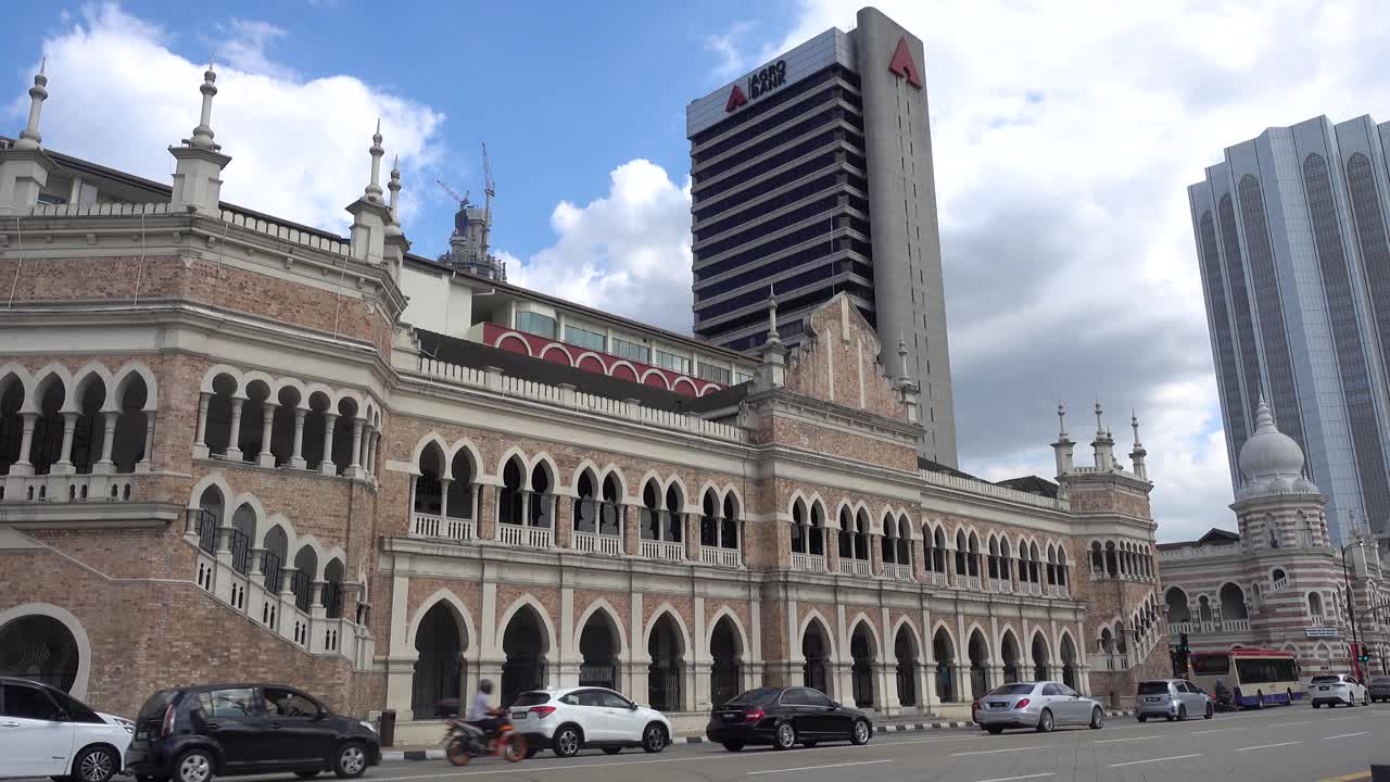 Dataran Merdeka traffic in bright blue sky with Museum Textile a cross the street