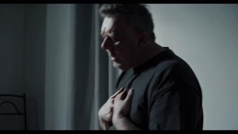 distressed man experiencing chest pain