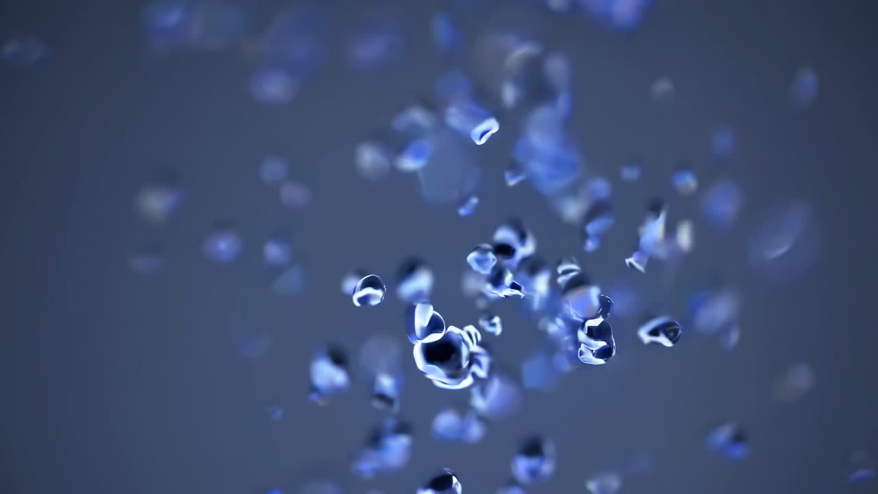 Abstract video of blue particles floating in mid-air, captured from a close-up angle