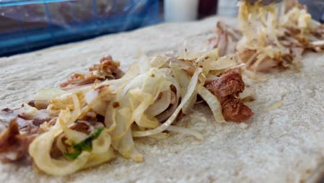 preparing a shawarma pita
