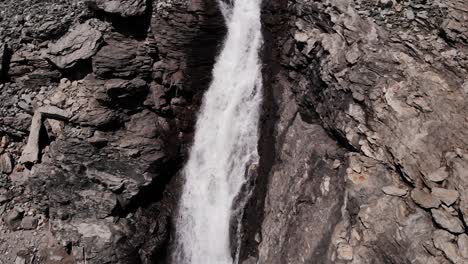 waterfall flowing on rocky cliff into waterfallboden reservoir in kaprun, australia