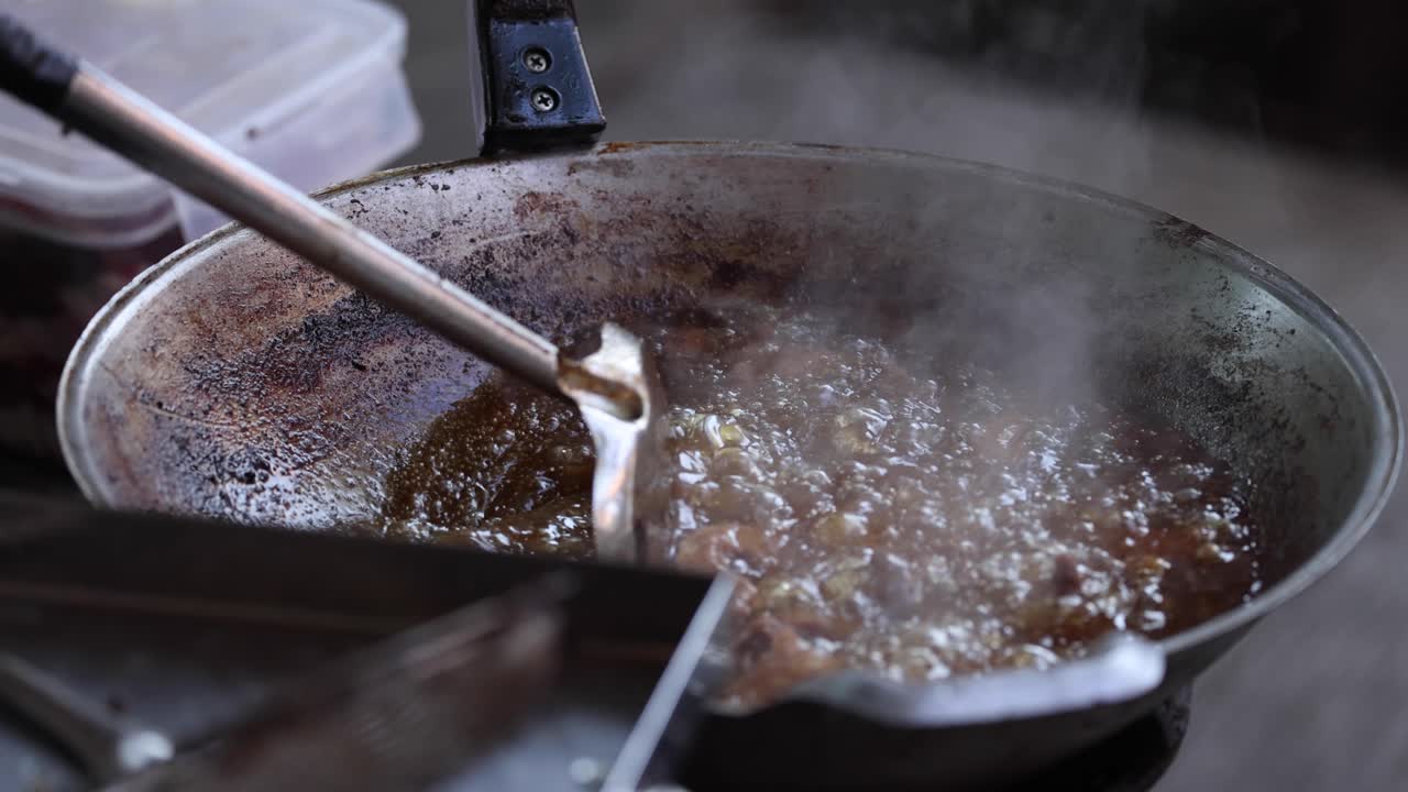 Stirring and frying meat in a hot pan
