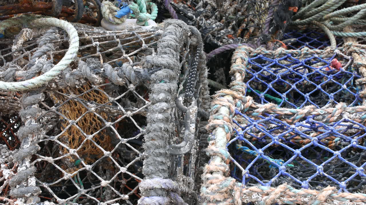 Fishing nets and ropes weathered with use shown in close-up detail at the harbor in Scarborough, North Yorkshire in England