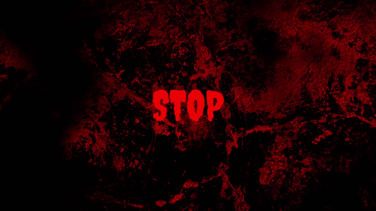 Testo Stop rosso lampeggiante su sfondo grunge scuro e sanguinolento