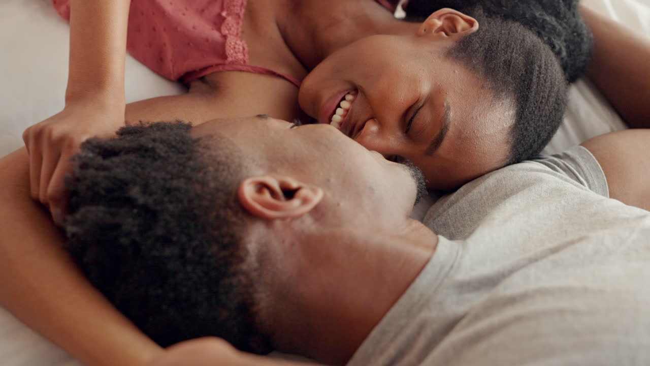 Love, bed and couple kiss and communication