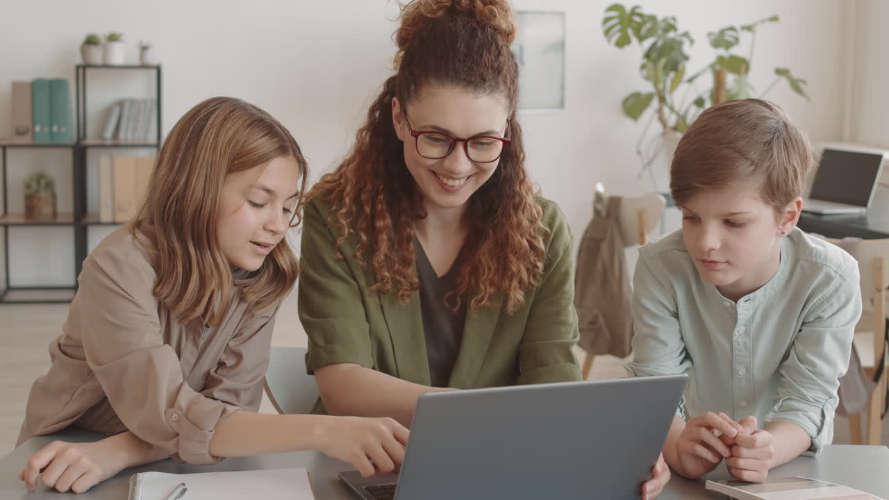 Students Standing at Desk of Teacher