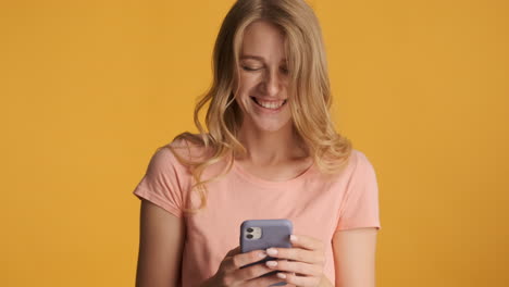 Caucasian woman using smartphone on camera.