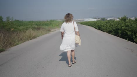 woman walking country road