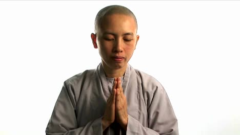 a young buddhist monk prays