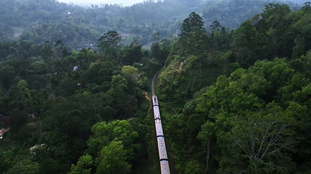 Scenic Train Journey Through Lush Green Mountain Landscape