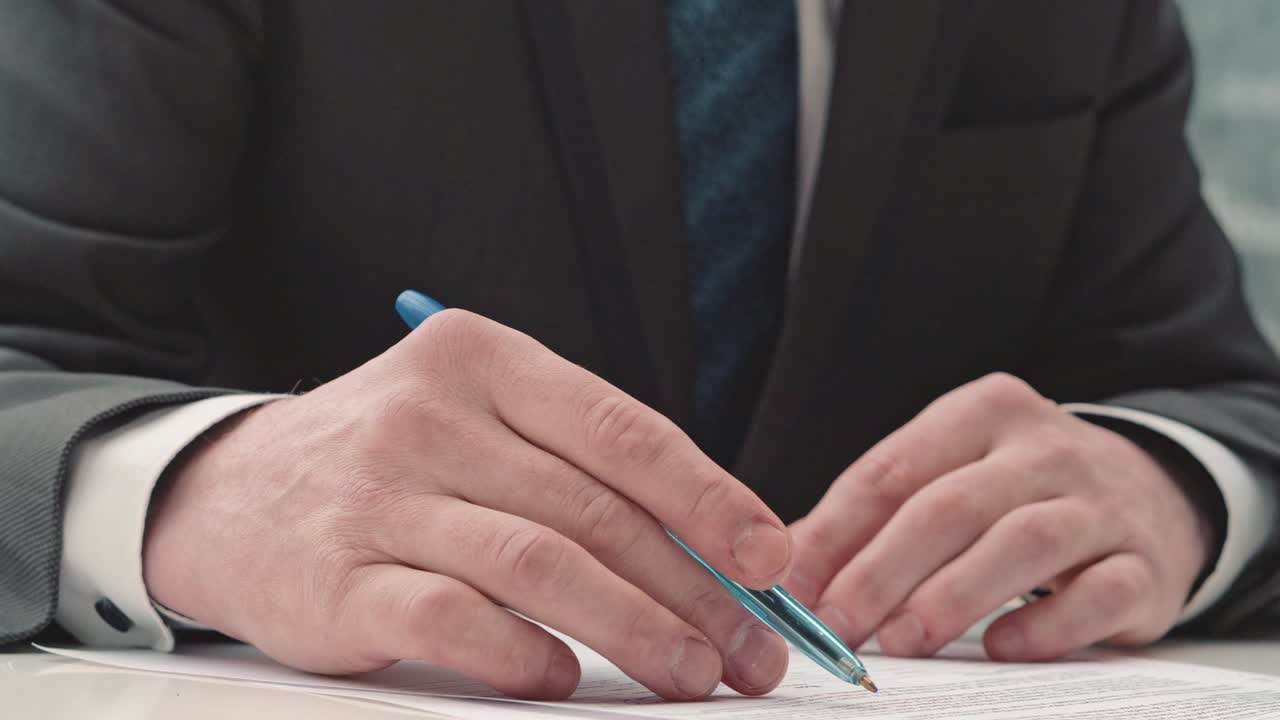 Businessman taking notes or signing contract, pen and document, man in formal jacket. Close up hand