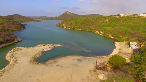 drone flying over lake between the hill site