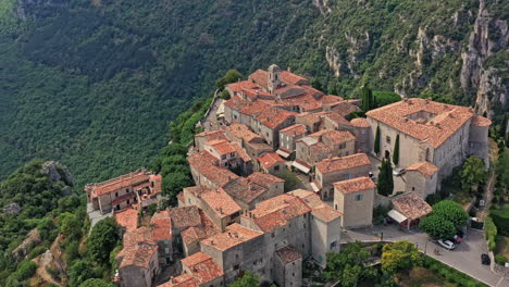 gourdon france aerial v2 birdseye view drone hovering around high altitude mountain clifftop old defensive stone castle ruins and village - july 2021