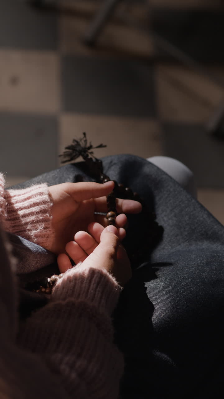 Hands Holding Rosary Beads