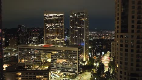 establishing cinematic view of century city between buildings, aerial flyover at night