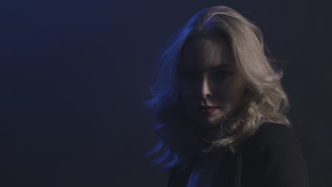 blonde woman portrait in dark studio