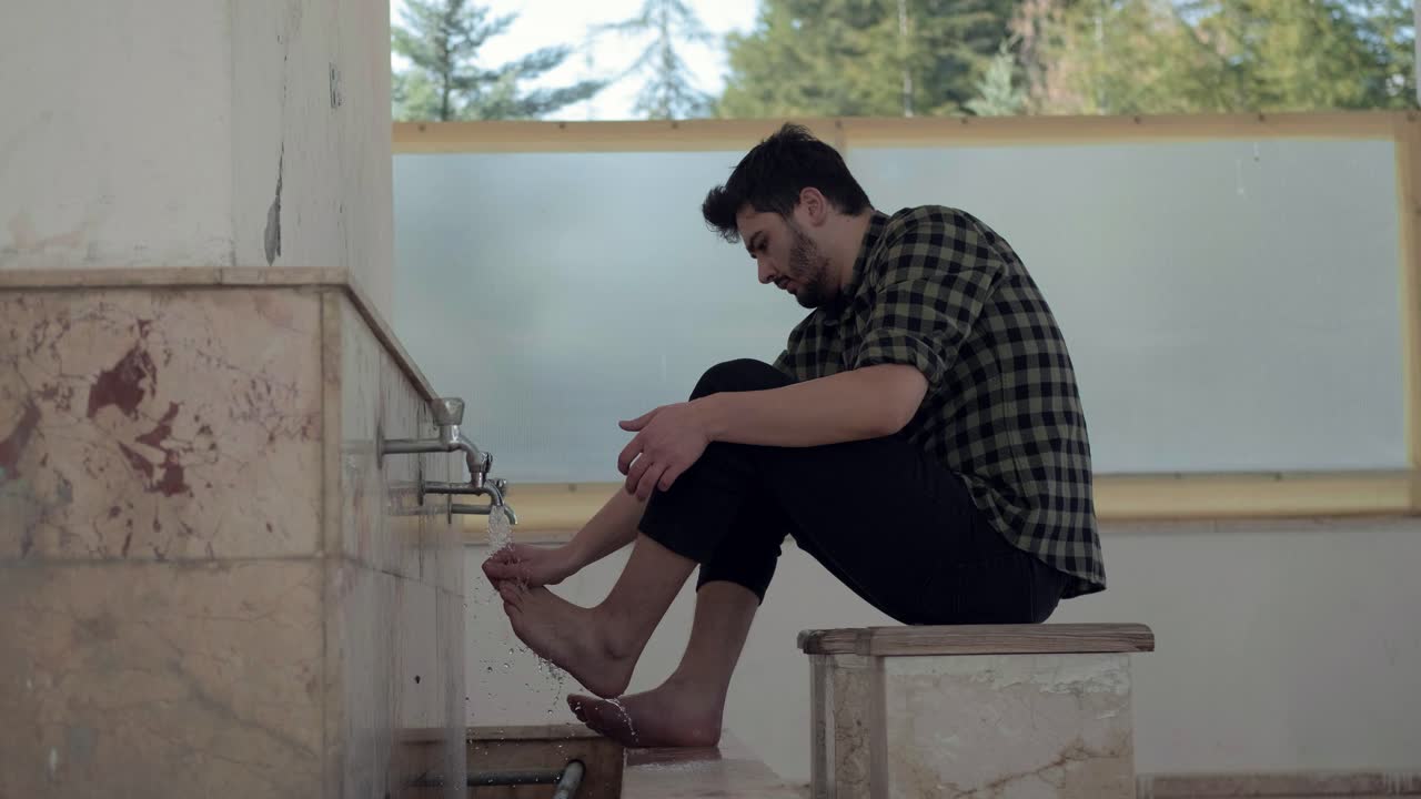 Young Muslim Man Taking Ablution For Prayer In Mosque 2