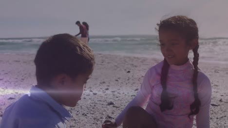 Animation-of-light-trails-over-biracial-children-playing-together-at-beach