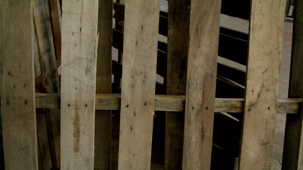 Construction site dolly right to left, close up of a pallet